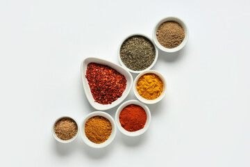 Bowls with fresh aromatic spices on light background