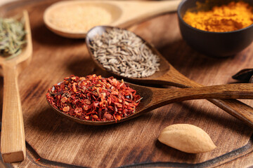 wooden board with aromatic spices, closeup