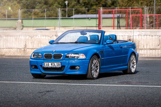 Blue sports car BMW M3 Cabrio stands outside on an asphalt parking lot. German fast premium car.