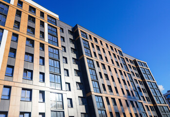 Modern facade building. Facade of high rise urban Modern house. balcony and Windows . Architecture building exterior, house block. High Rise house. Residential development in UK. City built. Blue sky.