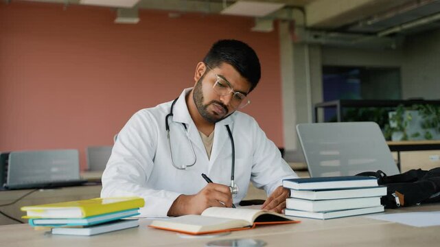 Indian medical intern studying for an exam at university