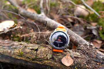 Smartwatch on autumn background. Sports watch for travel. Expedition smartwatch. Watch for survival...