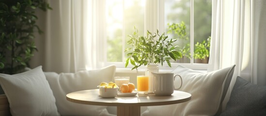 A cozy breakfast nook with a table set for one by a sunny window, featuring a glass of orange juice, a white mug, and a bowl of fruit.