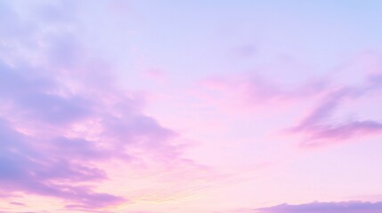 Obraz premium A soft pastel-colored dawn sky with gentle hues of pink and lavender, signaling the start of a new day.