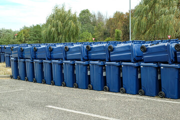 rows of new municipal colored trash cans with wheels, ready to be distributed to the population
