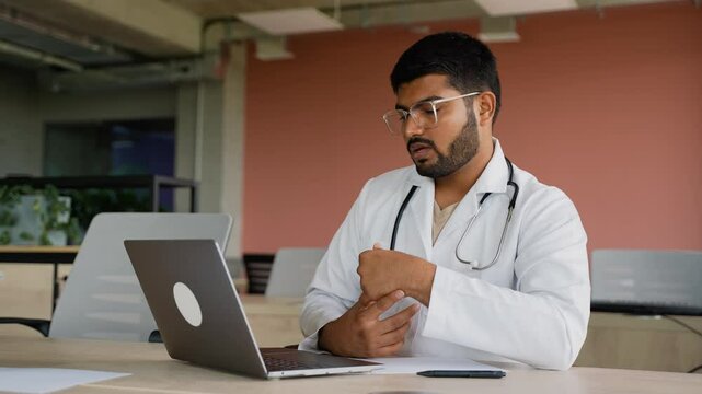Indian doctor attending online training session at the clinic
