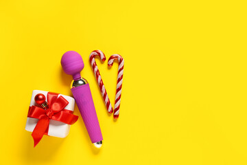 Vibrator, Christmas gift and decorations on yellow background