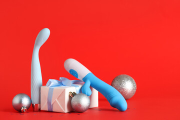 Vibrators, Christmas gift and decorations on red background