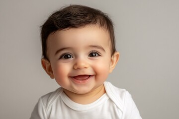 Naklejka premium Arab baby boy with olive skin and dark eyes, smiling on a neutral background 4