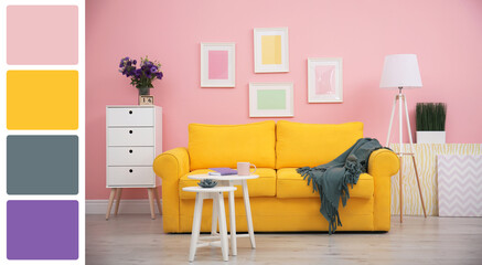 Stylish living room with comfortable sofa near pink wall. Interior design and matching color palette