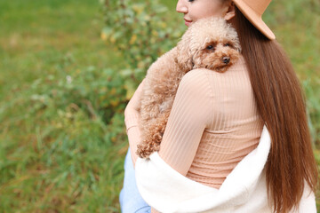 Woman with cute dog outdoors, closeup. Space for text