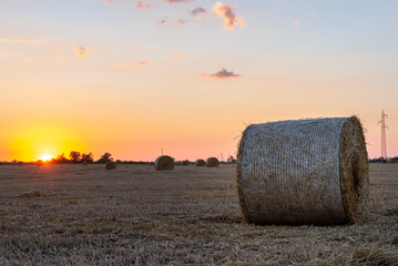 Straw bales in the field during sunset
