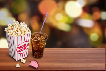 Tasty popcorn in bucket and movie clapper