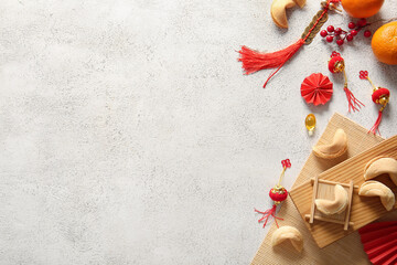 Chinese symbols with fortune cookies and mandarins on white grunge background. New Year celebration