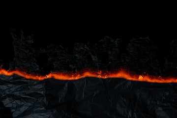 burning paper, glowing edge of paper on a black background