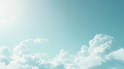 A clear blue sky with fluffy white clouds and sun shining.