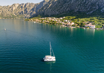 Yacht catamaran at anchor near the shore. Concept of active and luxurious rest