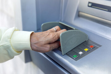 Person using an atm for secure banking transactions and money withdrawals