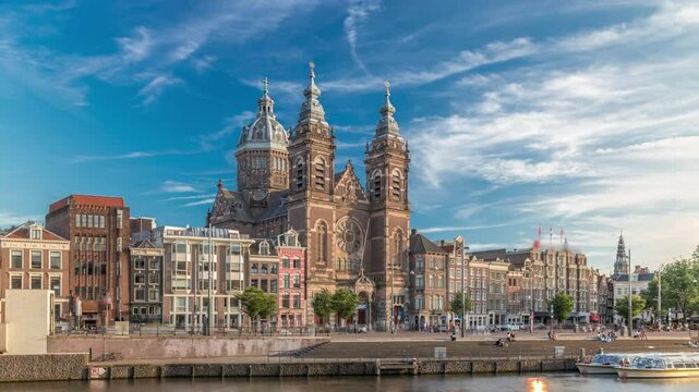 Hyperlapse of the Basilica of Saint Nicholas in Amsterdam's Old Centre near the Central Station. People walking along the waterfront by the boat station timelapse. Amsterdam, Netherlands