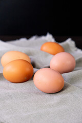Brown eggs on gray napkin. Vertical photo