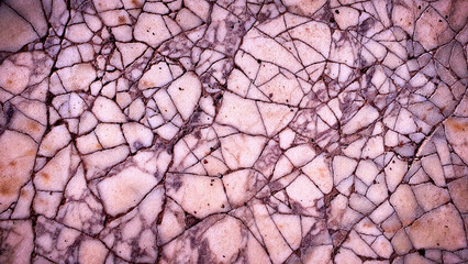 Obraz premium A cracked stone texture featuring soft pink, purple, and beige tones, offering a delicate and vintage-inspired backdrop for wallpapers, banners, and design templates