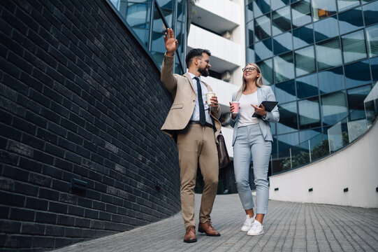 Business people talking and walking outside office building