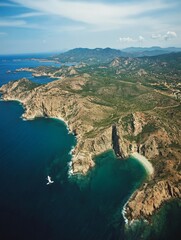 Obraz premium Aerial View of a Coastline with a Small Boat.
