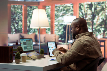 Entrepreneur conducting a data sales research with invoices and other expenses, planning a new...