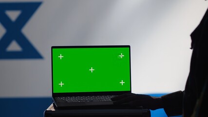 Israel secret police agent uses mass propaganda tools on green screen laptop to influence...