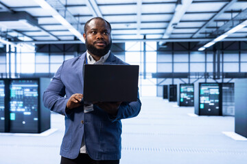 Engineer in data center implementing and managing data backup solutions to protect against data loss and ensuring efficient recovery processes, identifying and resolving technical issues