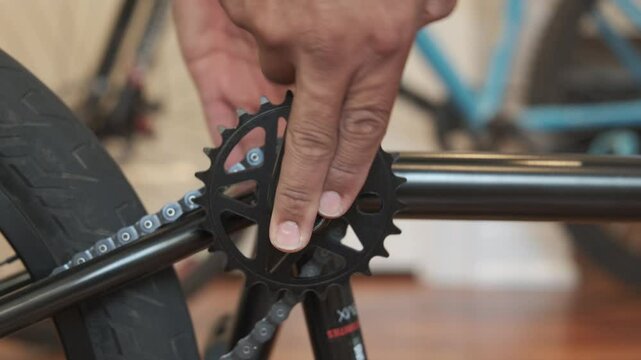 Unrecognizable man's hands installing a new bicycle chainring