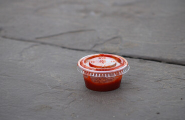 ketchup condiment sauce in plastic container