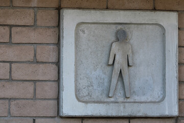 men bathroom concrete sign on brick wall