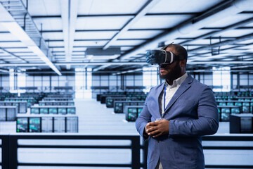 Programmer in server hub using VR headset to implement and maintain security measures, protecting systems from unauthorized access. Data center employee does hardware maintenance using virtual reality