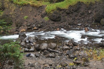 Serene River Flowing Through Rocky Landscape