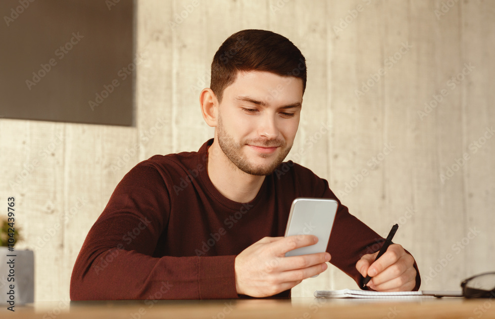 Poster Student Guy Using Smartphone Learning Sitting At Desk At Home. Educational Mobile Application. Selective Focus