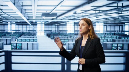 Software developer looking at holograms in data center, monitoring infrastructure. Woman in server...