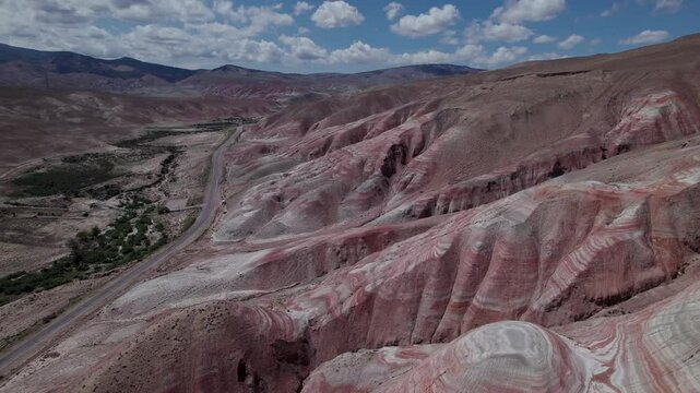 Stunning aerial drone footage of the unique Candy Cane Mountains, red and white striped formations near the Guba to Baku highway in Khizi District, Azerbaijan, Central Asia, Asia