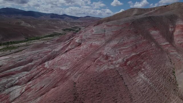 Stunning aerial drone footage of the unique Candy Cane Mountains, red and white striped formations near the Guba to Baku highway in Khizi District, Azerbaijan, Central Asia, Asia