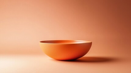 Minimalist orange ceramic bowl on matching background