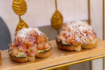 Toasts of dark bread with avocado slices, red tomatoes