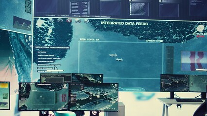 Federal army headquarters operation room with big screen used in monitoring satellite radar footage for threat oversight. Empty military agency command center with high tech gear.