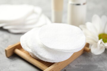 Clean cotton pads on grey table, closeup
