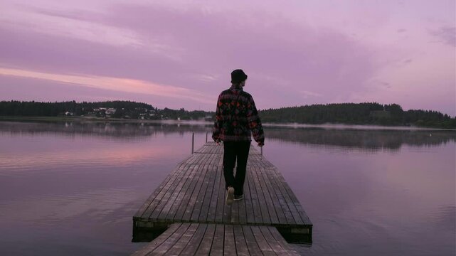 Man Walking Out on Pier in Midnight Sun, Stopping to Reflect, Peaceful Evening