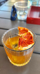 Burnt Orange Margarita at the bar freshly made. On table top, close up shot. Beautiful orange colored drink