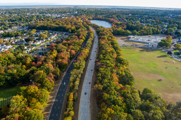 aerial view of road surrounded with trees fall colors.