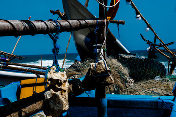 a blue boat with a rope attached to