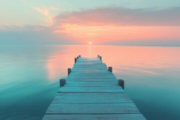 Obraz premium A wooden pier extends into a calm lake at sunset, with a vibrant sky in the background.