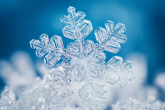 Micro photo. Symmetrical snowflake close-up on a blue background. Winter, snow. Ice sparkle, bokeh. Christmas card.