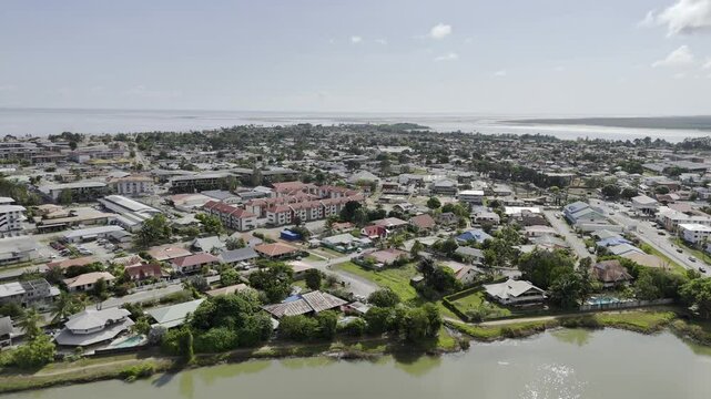 Drone flies over Lac du Bois Chaudat and over town hall in Kourou, French Guiana, France